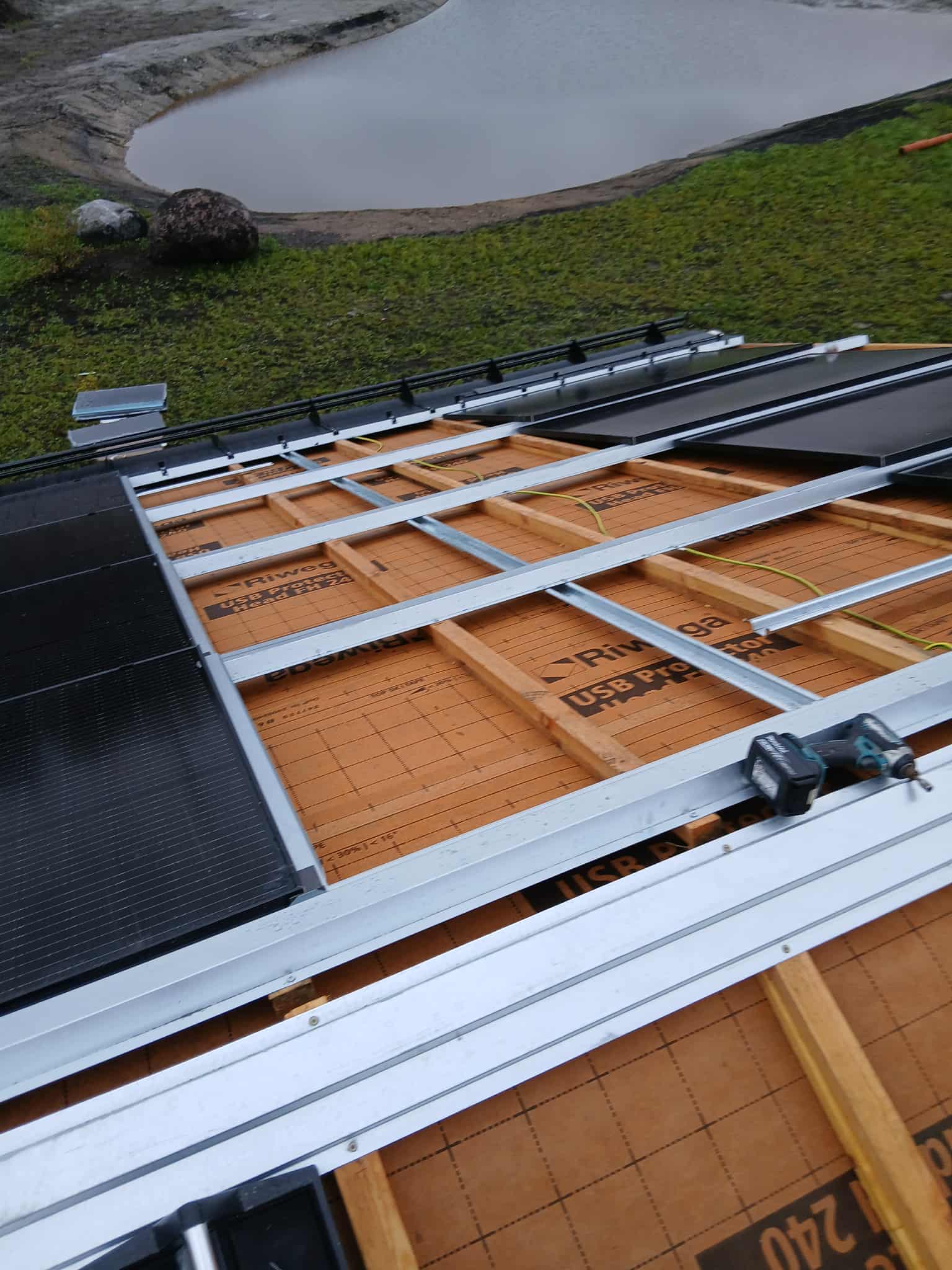 HolaRoof installation detail showing metal framework near pond