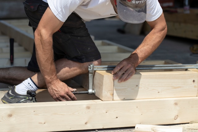 Professional roofer working on wooden roof construction
